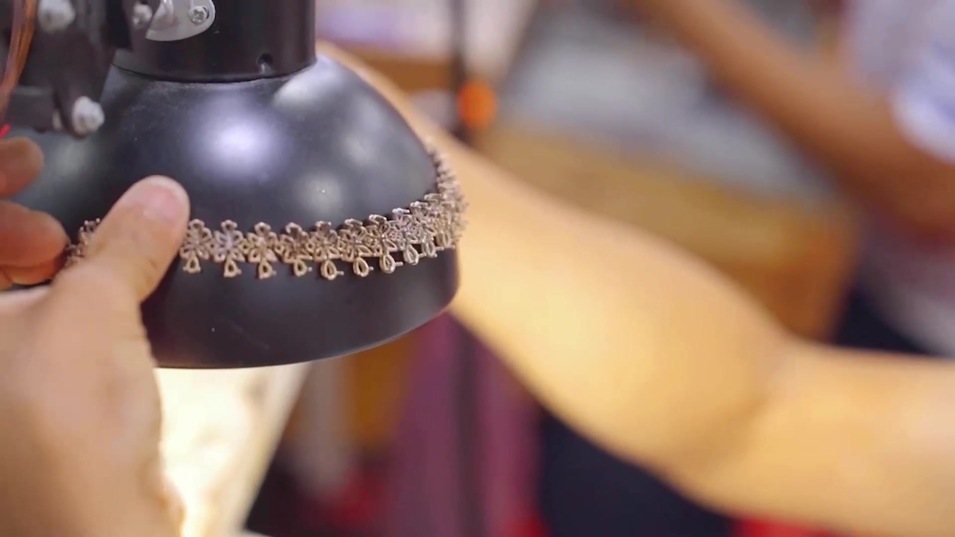 Hand inspecting fine jewelry